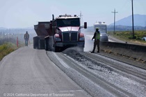 Trucks bring new paving material to be installed on westbound State Route 37 in Solano County on April 28, 2024.