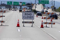 Cones and signage are used to close lanes and direct motorists on southbound I-680 to exit as they approach Pleasanton.