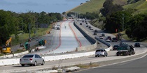 Cones show where new pavement has been installed on southbound Interstate 680 on April 28, 2024 while traffic flows on the northbound side.