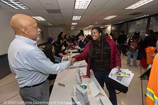 An exhibitor and attendee shake hands at the 2024 Equity Expo at Caltrans District 4.