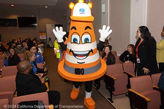 Caltrans mascot Safety Sam greets the audience during the opening remarks of the 2024 Equity Expo at Caltrans District 4.