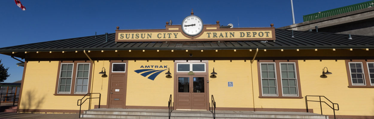 Banner image of the Suisun-Fairfield Amtrak Station entrance.