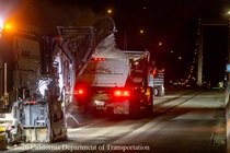 Heavy equipment removes the old roadway surface and deposits it into a truck on the Alfred Zampa Memorial (Carquinez) Bridge on the night of August 21, 2026.