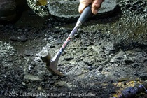 A hammer is used to pull up small pieces of the old roadway as part of the bridge deck rehabilitation project on the night of August 21, 2026.