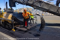 Heavy equipment and shovels are used to apply new roadway material as part of the bridge deck rehabilitation project on the Al Zampa Bridge on August 22, 2026.
