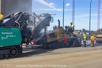 Heavy equipment and shovels are used to apply new roadway material as part of the bridge deck rehabilitation project on the Al Zampa Bridge on August 22, 2026.