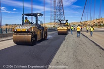 Heavy equipment is used to smooth the new roadway surface as part of the bridge deck rehabilitation project on the Al Zampa Bridge on August 22, 2026.