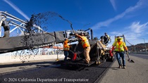 Heavy equipment and shovels are used to apply new roadway material as part of the bridge deck rehabilitation project on the Al Zampa Bridge on August 22, 2026.