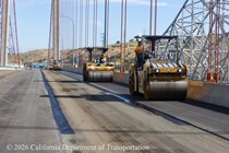 Caltrans uses heavy equipment to smooth the new roadway surface on the Alfred Zampa Memorial Bridge on August 23, 2026.