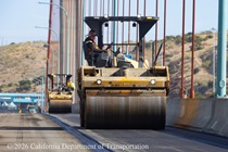 Caltrans uses heavy equipment to smooth the new roadway surface on the Alfred Zampa Memorial Bridge on August 23, 2026.