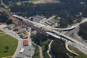 Aerial photo of the new Doyle Drive bridge and tunnel in San Francisco. A portion of the old Doyle Drive bridge is visible in the foreground.