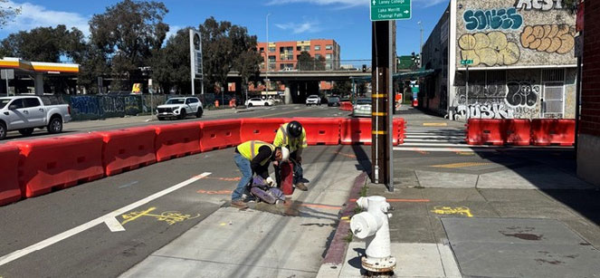 Caltrans crew setting up barriers and cones as the Oakland Alameda Access project begins.