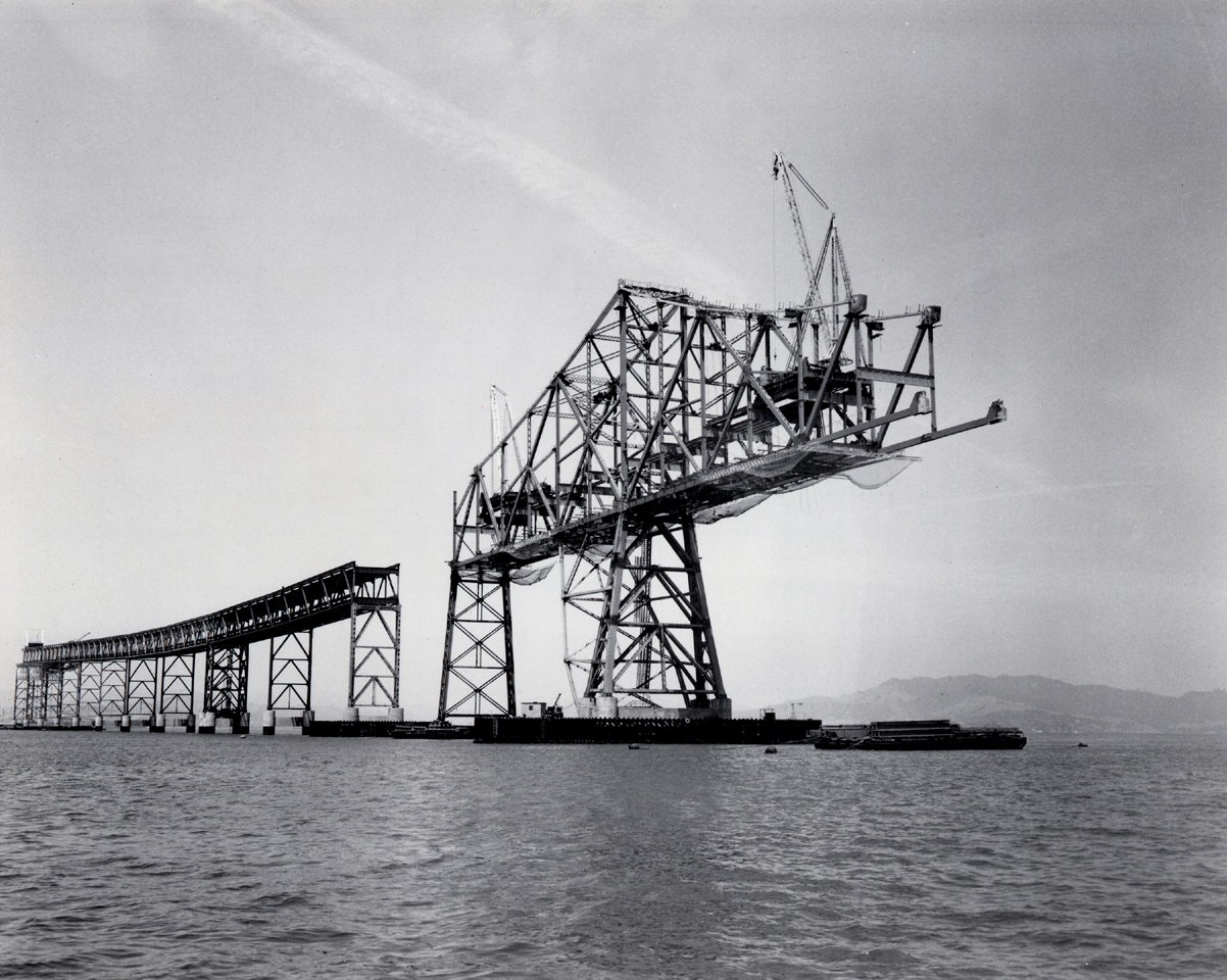 Black and white historical photo of the Richmond - San Rafael Bridge under construction.