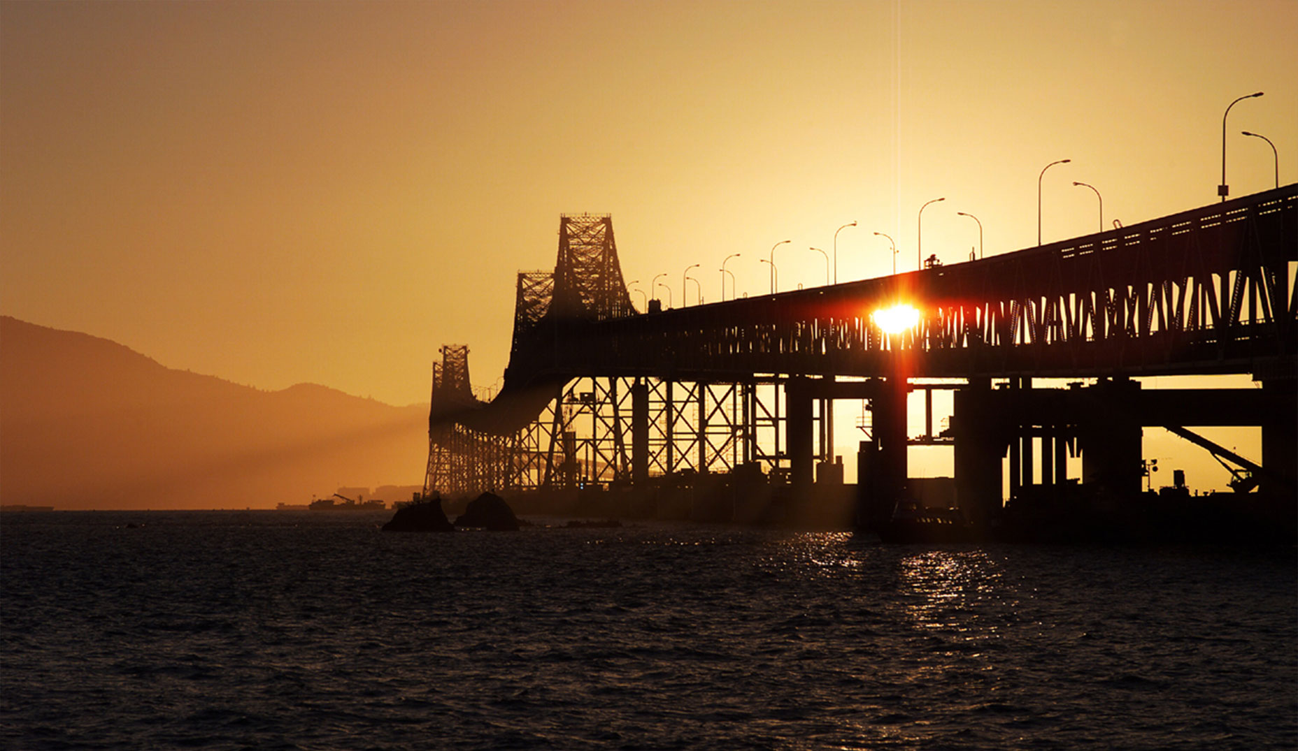 View of the Richmond - San Rafael Bridge with the sunset in the background.