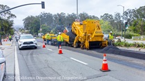 Cars traveling next to Caltrans workers using heavy equipment to resurface the existing asphalt pavement on Northbound 19th Avenue from Sloat Boulevard to Lincoln Way as work continues on the19th Avenue Paving and Rehabilitation project.