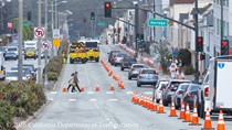 Pedestrian crossing a crosswalk as cars travel on 19th Avenue (State Route 1) as Caltrans is resurfacing the existing asphalt pavement on Northbound 19th Avenue from Sloat Boulevard to Lincoln Way as work continues on the19th Avenue Paving and Rehabilitation project.