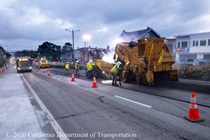 Cars travelling next to Caltrans using heavy equipment to resurface the existing asphalt pavement on Northbound 19th Avenue from Sloat Boulevard to Lincoln Way as work continues on the 19th Avenue Paving and Rehabilitation project.