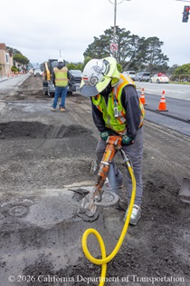 Cars drive by as Caltrans workers  preparing the roadway on SR-1 to replace the existing asphalt pavement on Northbound 19th Avenue from Sloat Boulevard to Lincoln Way as work continues on the 19th Avenue Paving and Rehabilitation project.