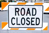 Road closed sign at an intersection where Caltrans is resurfacing the existing asphalt pavement on Northbound 19th Avenue from Sloat Boulevard to Lincoln Way as work continues on the 19th Avenue Paving and Rehabilitation project.