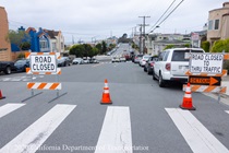 Road closed and detour sign at an intersection where Caltrans is resurfacing the existing asphalt pavement on Northbound 19th Avenue from Sloat Boulevard to Lincoln Way as work continues on the 19th Avenue Paving and Rehabilitation project.