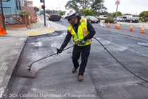 Caltrans worker spaying the newly paved asphalt on Northbound 19th Avenue from Sloat Boulevard to Lincoln Way as work continues on the 19th Avenue Paving and Rehabilitation project.