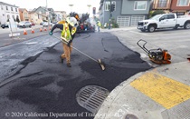 Caltrans worker leveling the newly paved asphalt on Northbound 19th Avenue from Sloat Boulevard to Lincoln Way as work continues on the 19th Avenue Paving and Rehabilitation project.
