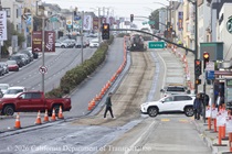 Vehicle and pedestrian traffic cross through the 19th Avenue (State Route 1) Rehabilitation Project at the intersection with Irving Street.