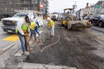 Caltrans crew uses a mix of tools and heavy equipment to remove the old roadway surface on southbound 19th Avenue (State Route 1) at the intersection with Lawton Street on May 9, 2026.