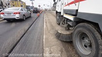 A sweeper truck was used to remove small debris after the old roadway surface was removed on southbound 19th Avenue (State Route 1) near Lawton Street on May 9, 2026. Vehicle traffic continues to flow in the left lane during construction.