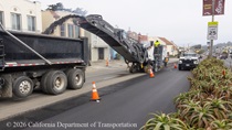 Caltrans uses heavy equipment to remove the old roadway surface and convey it into a truck for removal on southbound 19th Avenue (State Route 1) in San Francisco on May 9, 2026. One lane of southbound 19th Avenue remains open for vehicle traffic during construction.