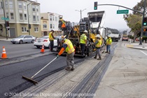A Caltrans crew uses heavy equipment and other tools to repave the center lane of 19th Avenue (State Route 1) at the intersection with Santiago Street on May 9, 2026.
