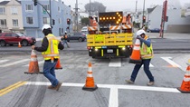 Two Caltrans crewmembers deploy cones to direct traffic at the intersection of southbound 19th Avenue (State Route 1) and Pacheco Street as part of the 19th Avenue Paving and Rehabilitation Project on May 10, 2026. 