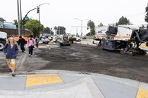 Pedestrians crossing an intersection on 19th Avenue (State Route 1) as Caltrans is using heavy equipment to resurface the existing asphalt pavement on Southbound/Northbound 19th Avenue from Sloat Boulevard to Holloway Avenue as work continues on the third of three weekend closures for the 19th Avenue Rehabilitation Project.