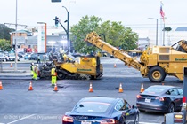 Caltrans crew using heavy equipment to resurface the existing asphalt pavement as cars drive by on Southbound/Northbound 19th Avenue from Sloat Boulevard to Holloway Avenue as work continues on the third of three weekend closures for the 19th Avenue Rehabilitation Project.