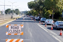 Road closed sign next to cars traveling on newly resurfaced asphalt on 19th Avenue (State Route 1) as Caltrans continues resurfacing the existing asphalt pavement on Southbound/Northbound 19th Avenue from Sloat Boulevard to Holloway Avenue as work continues on the third of three weekend closures for the 19th Avenue Rehabilitation Project.