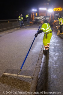 Caltrans crew prepares new road surface on Eastbound Interstate 80 in San Francisco on the night of April 17, 2026.