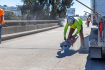 Caltrans crew using a saw finishing up the newly completed polyester overlay on the WB I-80 Bayshore Freeway on October 24, 2026. The purpose of this closure is to perform the polyester overlay of the Bayshore viaduct between 4th street and the I-80/US-101 interchange.