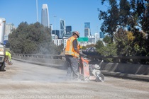 Caltrans crew using a saw finishing up the newly completed polyester overlay on the WB I-80 Bayshore Freeway on October 24, 2026. The purpose of this closure is to perform the polyester overlay of the Bayshore viaduct between 4th street and the I-80/US-101 interchange.