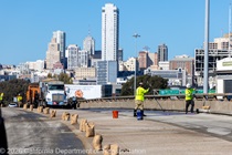 Caltrans crews finishing up the newly completed polyester overlay on the WB I-80 Bayshore Freeway as cars drive by on the open lanes on October 24, 2026. The purpose of this closure is to perform the polyester overlay of the Bayshore viaduct between 4th street and the I-80/US-101 interchange.