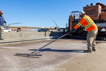 Caltrans crews finishing up the newly completed polyester overlay on the WB I-80 Bayshore Freeway as cars drive by on the open lanes on October 24, 2026. The purpose of this closure is to perform the polyester overlay of the Bayshore viaduct between 4th street and the I-80/US-101 interchange.