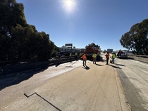 Caltrans crews finishing up the newly completed polyester overlay on lane 1 of the WB I-80 Bayshore Freeway on October 24, 2026. The purpose of this closure is to perform the polyester overlay of the Bayshore viaduct between 4th street and the I-80/US-101 interchange.