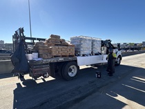 Caltrans crew next to a truck loaded with supplies, preparing to finish up the newly completed polyester overlay on lane 1 of the WB I-80 Bayshore Freeway on October 24, 2026. The purpose of this closure is to perform the polyester overlay of the Bayshore viaduct between 4th street and the I-80/US-101 interchange.