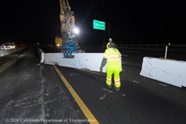 Caltrans crew members place temporary barriers as part of the US 101 Hospital Curve Rehabilitation Project on March 13, 2026.