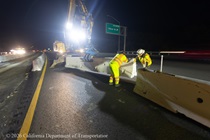 Caltrans crew members set up temporary barriers as part of the US 101 Hospital Curve Rehabilitation Project on March 13, 2026.