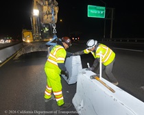 Caltrans crew members install temporary barriers as part of the US 101 Hospital Curve Rehabilitation Project on March 13, 2026.