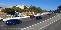 Traffic continues to flow on US 101 as a temporary barrier separates motorists from the construction of the new median barrier in San Francisco..