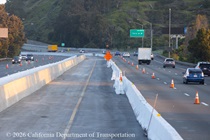 Segment of new concrete median (left) on US 101 in San Francisco. Temporary barriers separate traffic from the new median construction.