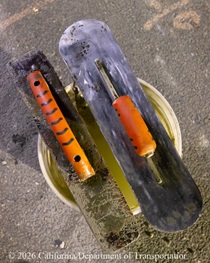 Tools on top of a bucket used for the construction of a new median barrier as part of the US 101 Hospital Curve Rehabilitation Project on March 27, 2026.