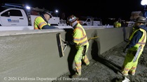 Caltrans crew member performs finishing work on the fresh concrete for the new median barrier as part of the US 101 Hospital Curve Rehabilitation Project on March 27, 2026.