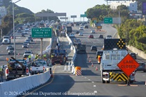 Cars traveling on US 101 at Paul Ave with signs indication lane closures as Caltrans continues construction of a new median barrier as part of the US 101 Hospital Curve Rehabilitation Project on March 28, 2026.